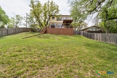 25420 Cove Dr, Spicewood, TX 78669 - view of yard featuring stairs, a wooden deck, and a fenced backyard