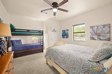 25420 Cove Dr, Spicewood, TX 78669 - bedroom featuring visible vents, a ceiling fan, and carpet
