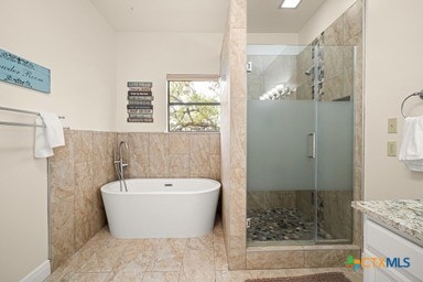 25420 Cove Dr, Spicewood, TX 78669 - bathroom with a freestanding tub, vanity, and a shower stall