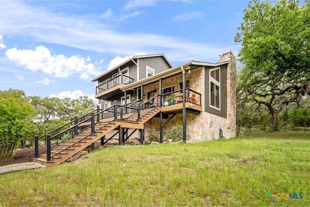 805 Sunrise Trl, Spring Branch, TX 78070 - back of property with stone siding, stairway, and a wooden deck