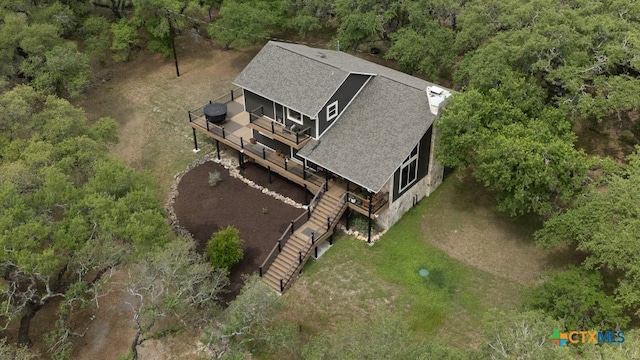 birds eye view of property featuring a wooded view