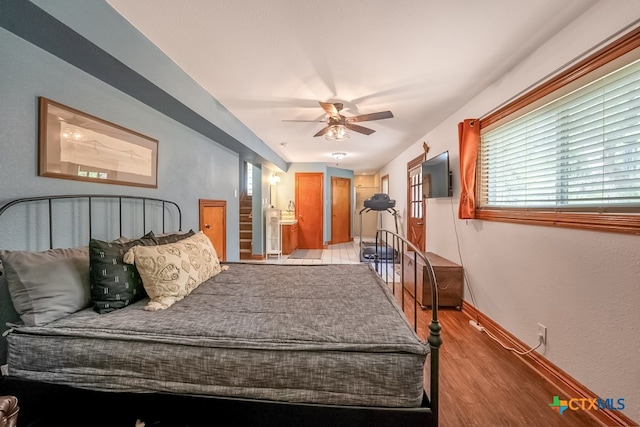 bedroom with baseboards, wood finished floors, and a ceiling fan