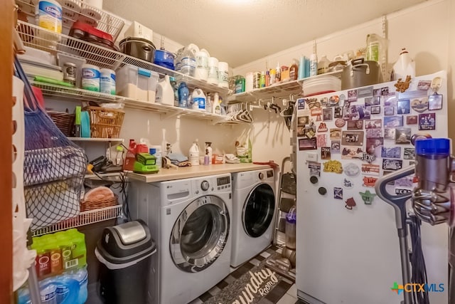 clothes washing area featuring washer and dryer and laundry area