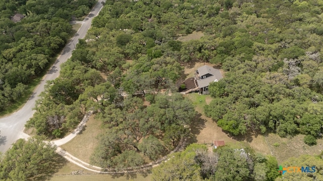 birds eye view of property with a view of trees