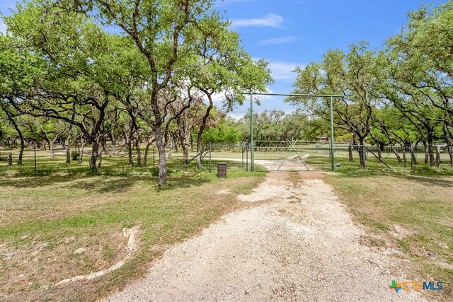 805 Sunrise Trl, Spring Branch, TX 78070 - view of road featuring a gate and view of scattered trees
