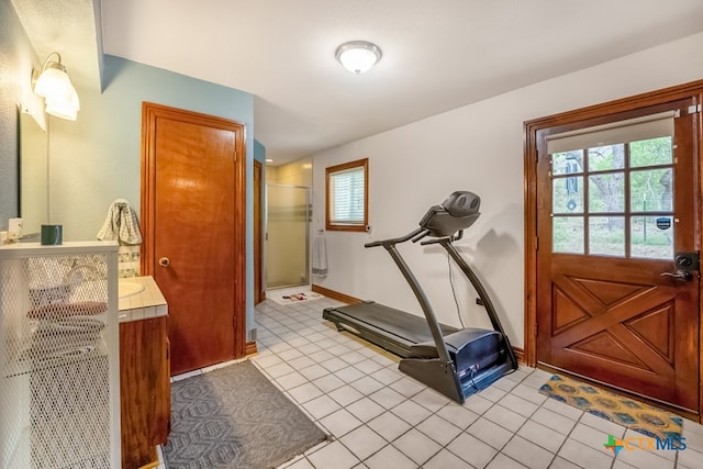 exercise room with light tile patterned floors