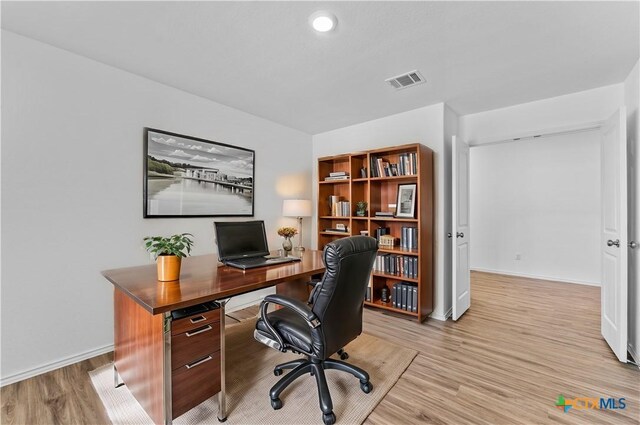 130 Carmello, Kyle, TX 78640 - office featuring baseboards, visible vents, and light wood finished floors