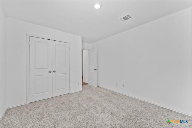 130 Carmello, Kyle, TX 78640 - unfurnished bedroom with a closet, carpet floors, and visible vents