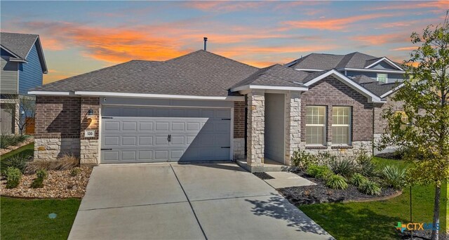 130 Carmello, Kyle, TX 78640 - view of front of house featuring stone siding, concrete driveway, a shingled roof, and an attached garage