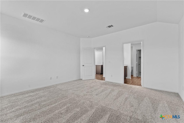 130 Carmello, Kyle, TX 78640 - unfurnished bedroom with baseboards, carpet, lofted ceiling, and visible vents