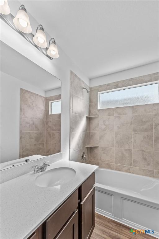 130 Carmello, Kyle, TX 78640 - full bathroom with shower / washtub combination, wood finished floors, vanity, and plenty of natural light
