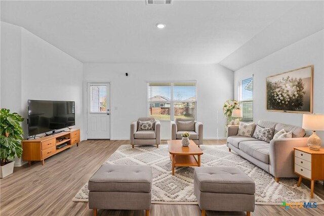 130 Carmello, Kyle, TX 78640 - living area with baseboards, visible vents, vaulted ceiling, and light wood finished floors