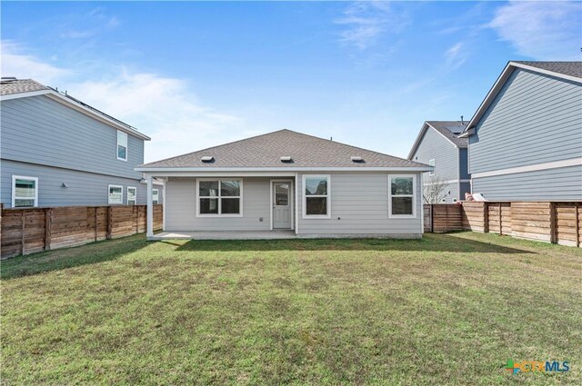 130 Carmello, Kyle, TX 78640 - rear view of house featuring a lawn, a fenced backyard, a patio, and roof with shingles