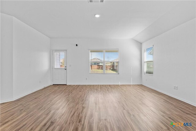 130 Carmello, Kyle, TX 78640 - unfurnished room with a wealth of natural light, baseboards, visible vents, and light wood-type flooring