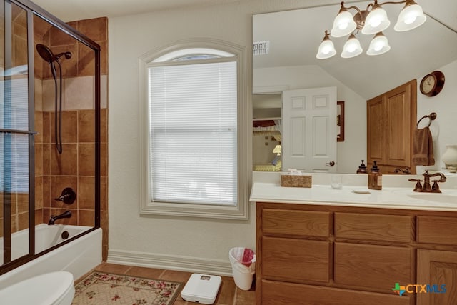 full bathroom with tile patterned floors, toilet, shower / bath combination with glass door, vanity, and a notable chandelier