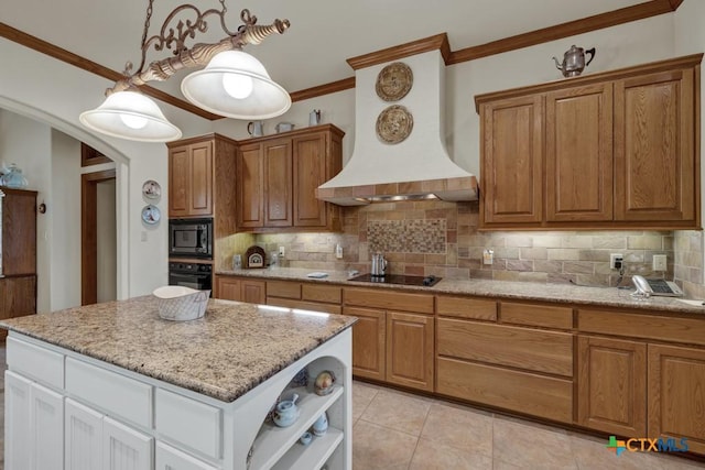 kitchen featuring decorative backsplash, white cabinets, custom exhaust hood, and black appliances