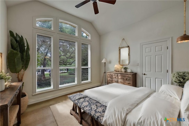 bedroom with vaulted ceiling, wood-type flooring, and ceiling fan