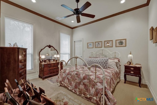 bedroom with crown molding, light colored carpet, and ceiling fan