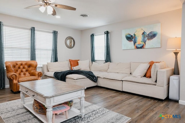 living room featuring light wood-type flooring, visible vents, a ceiling fan, and recessed lighting