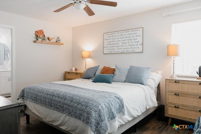 bedroom featuring dark wood-style floors, a ceiling fan, and ensuite bathroom