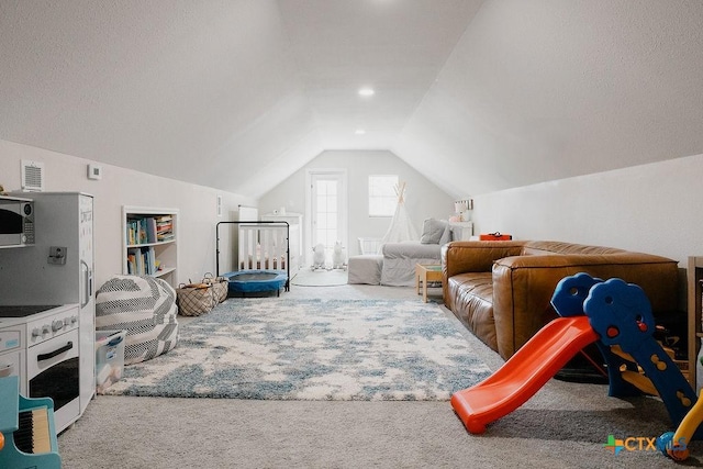 playroom with vaulted ceiling and carpet flooring