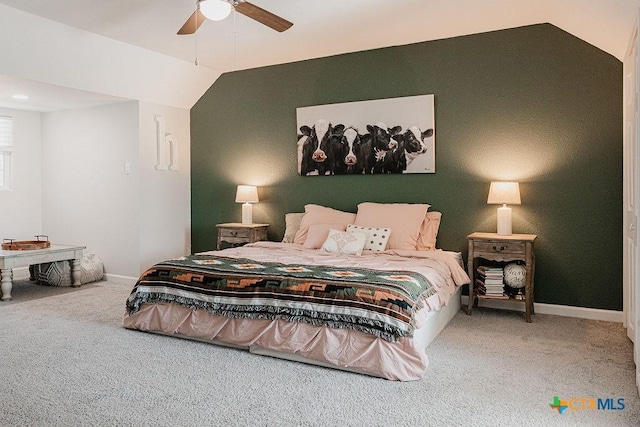 carpeted bedroom featuring a ceiling fan, vaulted ceiling, and baseboards