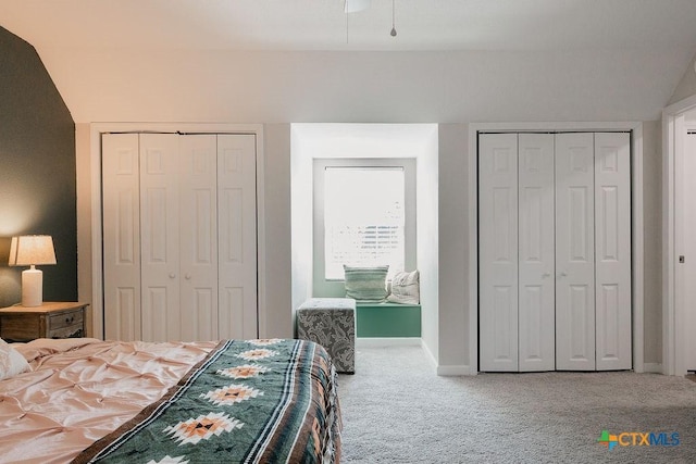 bedroom featuring baseboards, carpet flooring, and multiple closets