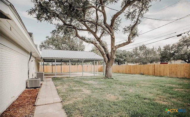 view of yard featuring a fenced backyard, central AC unit, and a patio