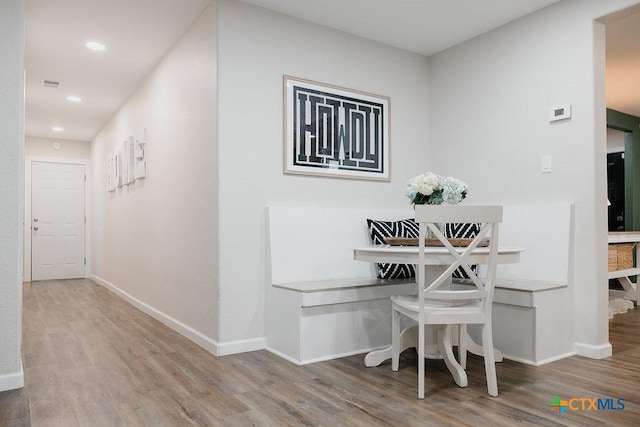 dining area featuring wood finished floors and baseboards