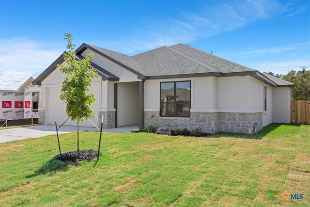 view of front of property featuring a garage and a front yard