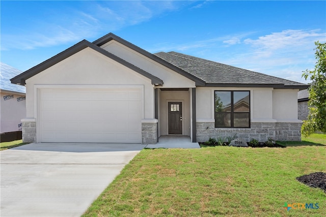 view of front of home featuring a garage and a front yard