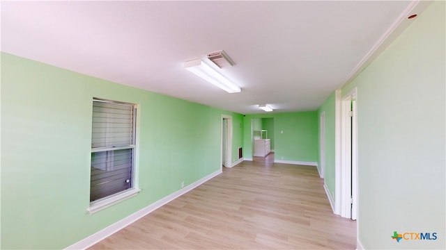 hallway with light hardwood / wood-style flooring