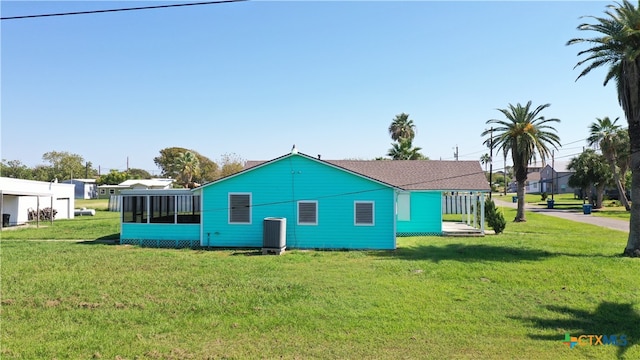 view of property exterior featuring a sunroom and a yard