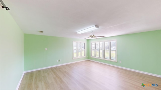 spare room with ceiling fan and light hardwood / wood-style floors