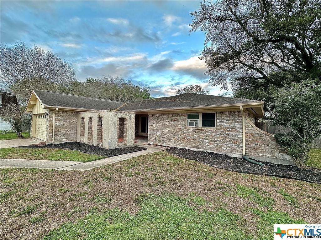 view of front of house with a garage and a front lawn