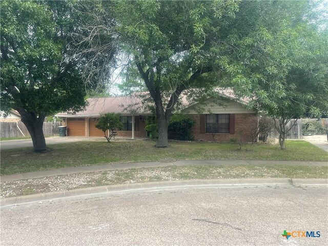 single story home featuring a garage and a front lawn