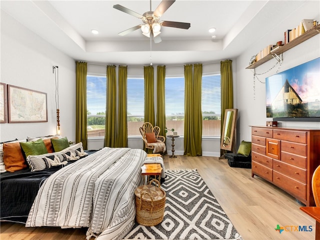 4508 River Rock Rd, Marion, TX 78124 - bedroom featuring a raised ceiling, light wood finished floors, recessed lighting, ceiling fan, and baseboards
