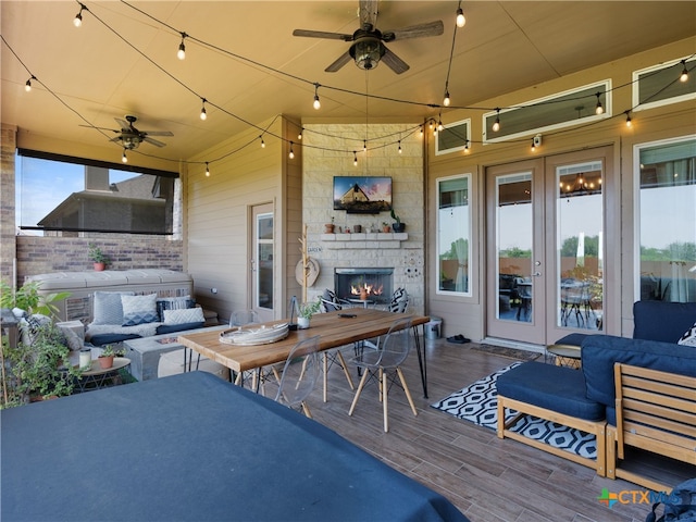4508 River Rock Rd, Marion, TX 78124 - view of patio featuring french doors, a ceiling fan, an outdoor living space with a fireplace, a wooden deck, and outdoor dining area