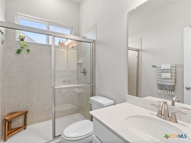 4508 River Rock Rd, Marion, TX 78124 - full bathroom with vanity, toilet, a stall shower, and a textured wall