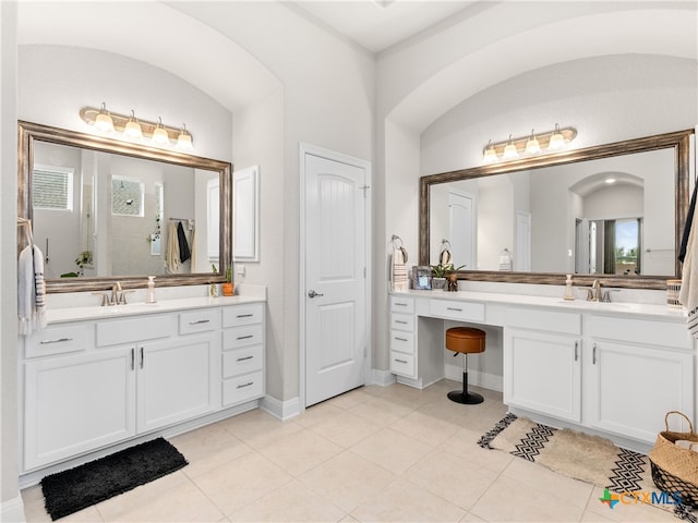 4508 River Rock Rd, Marion, TX 78124 - full bathroom featuring two vanities, tile patterned flooring, and baseboards