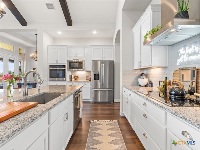4508 River Rock Rd, Marion, TX 78124 - kitchen with stainless steel appliances, wall chimney range hood, a sink, beam ceiling, and white cabinets