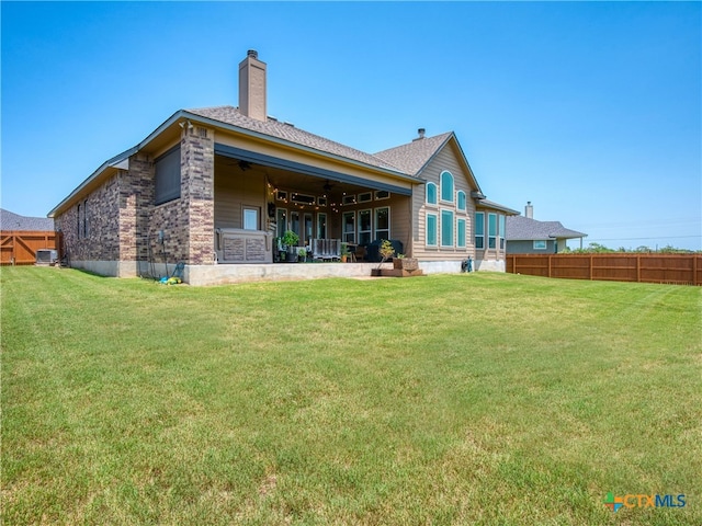 4508 River Rock Rd, Marion, TX 78124 - back of house with a chimney, a ceiling fan, central AC, and roof with shingles