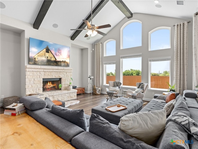 4508 River Rock Rd, Marion, TX 78124 - living room featuring beam ceiling, wood finished floors, ceiling fan, a stone fireplace, and high vaulted ceiling