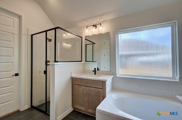 bathroom with plus walk in shower, vanity, and lofted ceiling