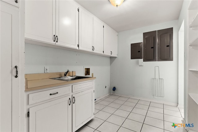 washroom with cabinets, hookup for a washing machine, light tile patterned floors, and sink