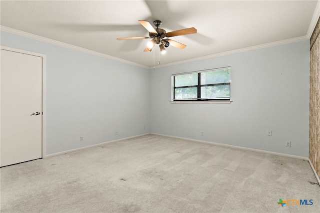 empty room featuring light colored carpet, ceiling fan, and crown molding