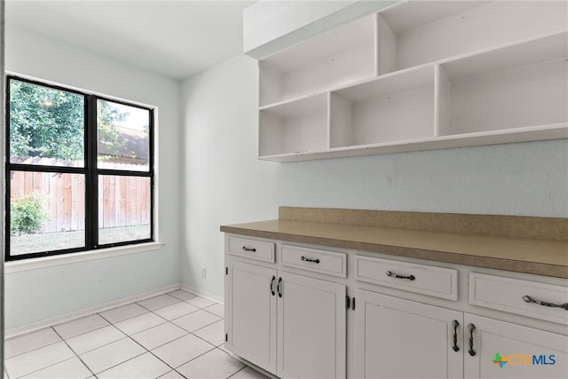 kitchen featuring white cabinets and light tile patterned flooring