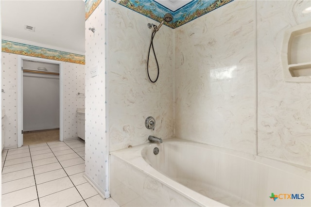 bathroom featuring tile patterned floors, crown molding, and tiled shower / bath combo