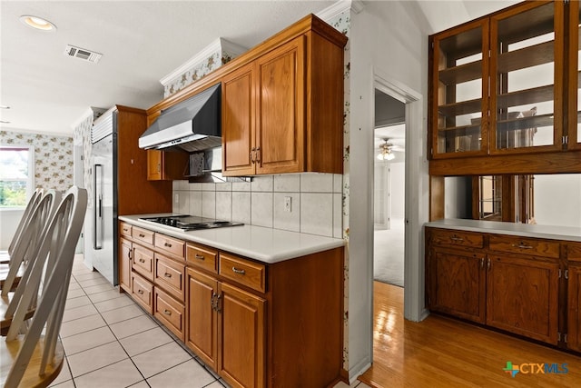 kitchen with stainless steel built in fridge, ceiling fan, light tile patterned floors, extractor fan, and gas cooktop