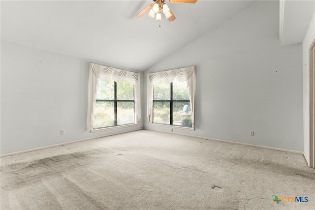 carpeted spare room featuring ceiling fan and high vaulted ceiling